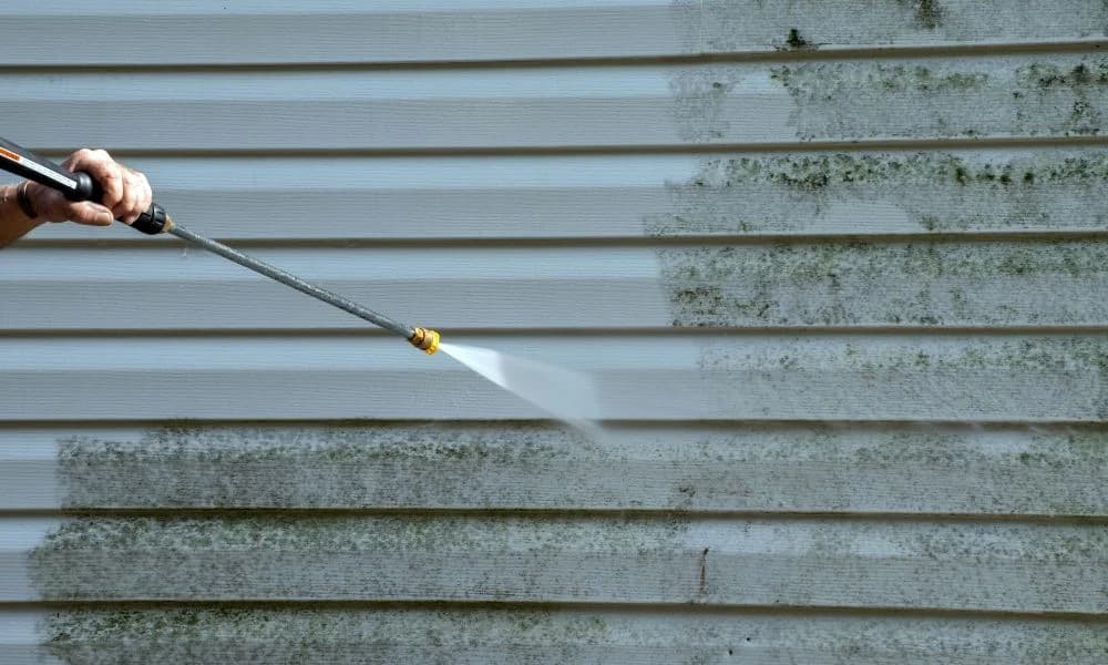 Pressure washing dirty siding to restore a cleaner exterior finish